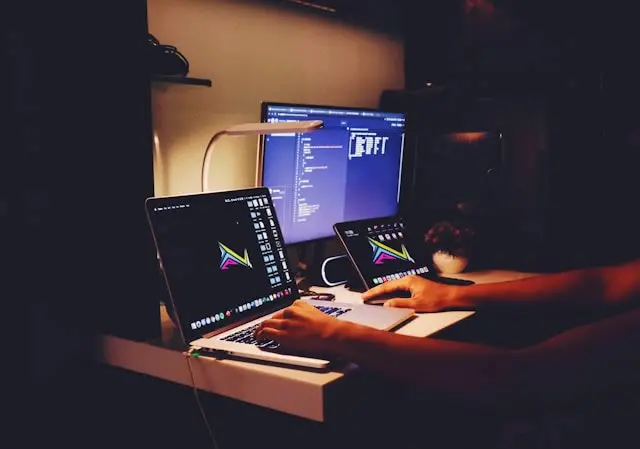 Email developer workspace with laptop showing code